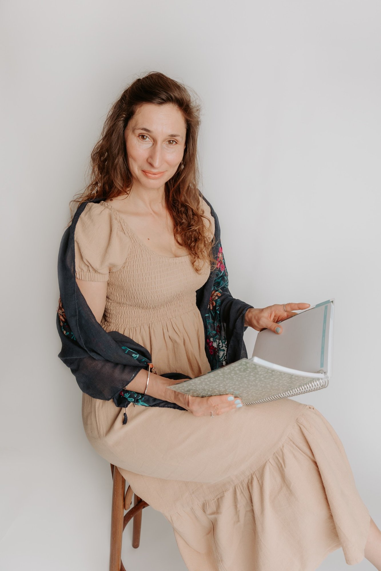 Patrycja, creator of Mum, and More, seated with an open notebook
